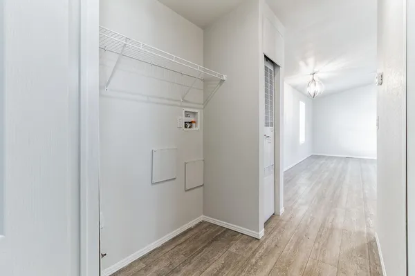 a view of hallway with wooden floor