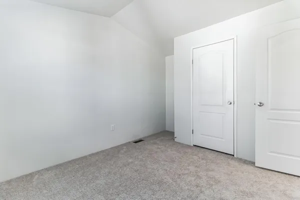 an empty room with closet area