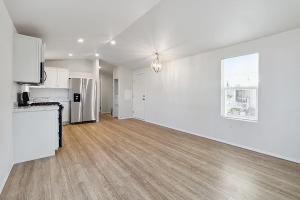 a view of a kitchen with a sink and a refrigerator