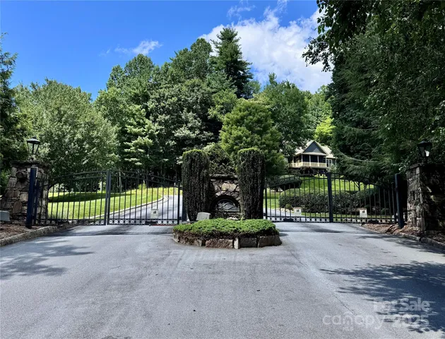 a view of a park with iron fence
