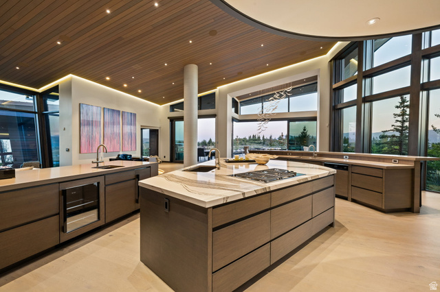 8544 North Promontory Ranch Road Park City, UT 84098 - Photo 8 of 36 Kitchen with modern cabinets, light wood finished floors, dishwashing machine, light stone counters, and a high wood ceiling