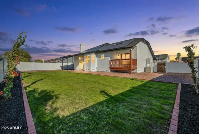 an aerial view of multiple houses with a big yard