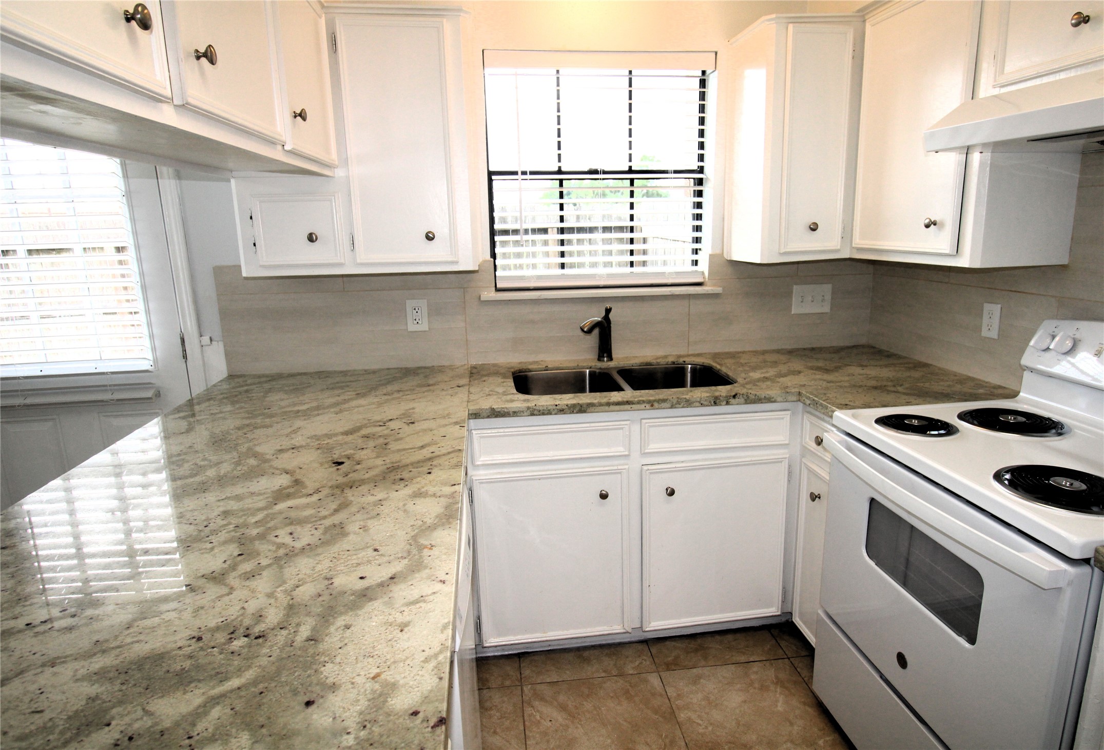1101 Wilson Drive Rosenberg, TX 77471 - Photo 16 of 38 VIEW SHOWS TILE BACKSPLASH EVEN BEHIND THE STOVE UP TO THE CABINETS!