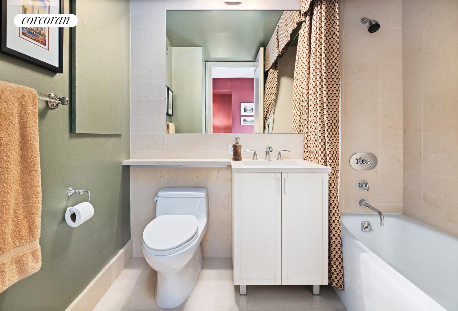 25 Columbus Circle, Unit 61G Manhattan, NY 10035 - Photo 11 of 23 a white toilet sitting next to a bathroom sink