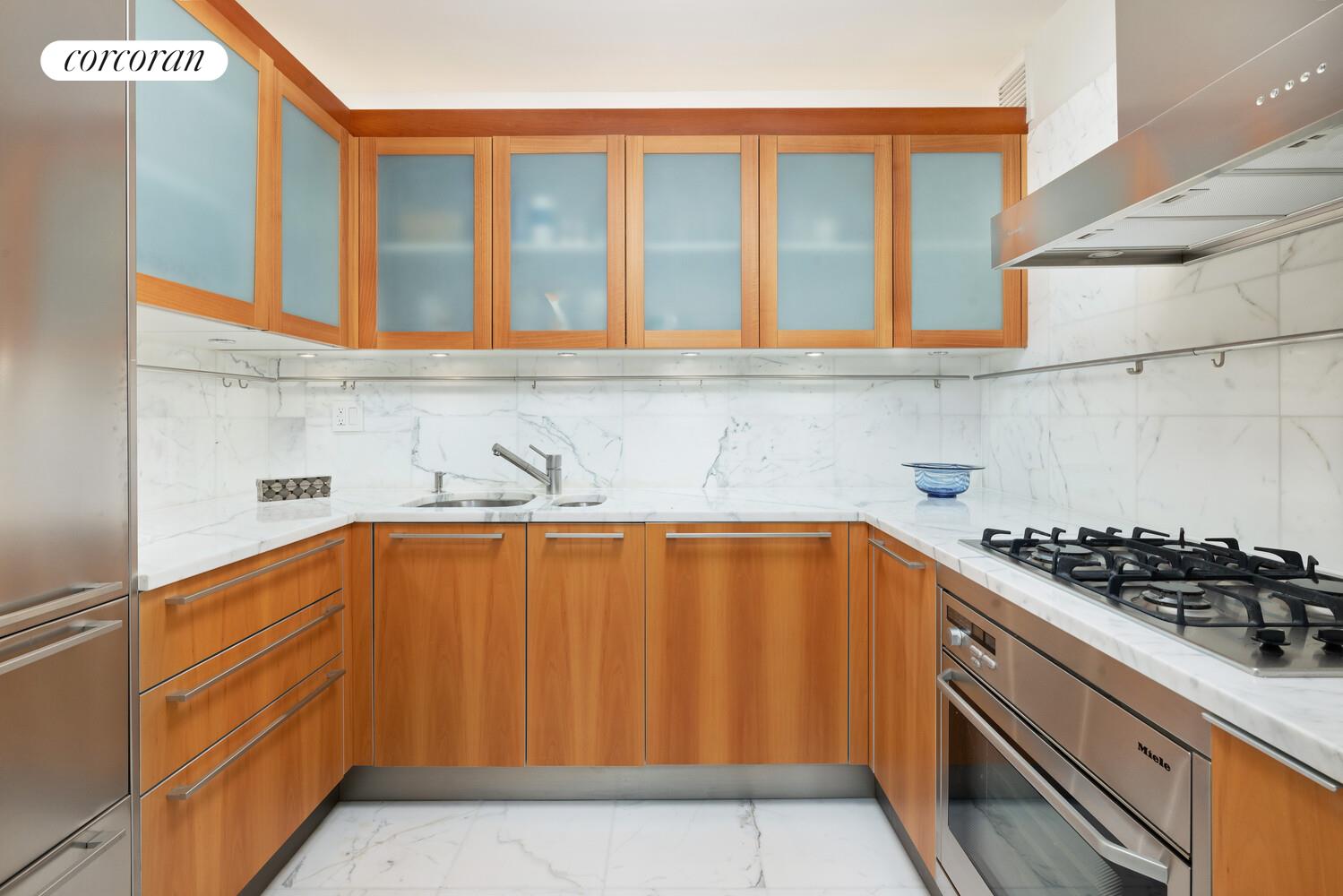 25 Columbus Circle, Unit 61G Manhattan, NY 10035 - Photo 7 of 23 a kitchen with stainless steel appliances granite countertop a sink stove and cabinets