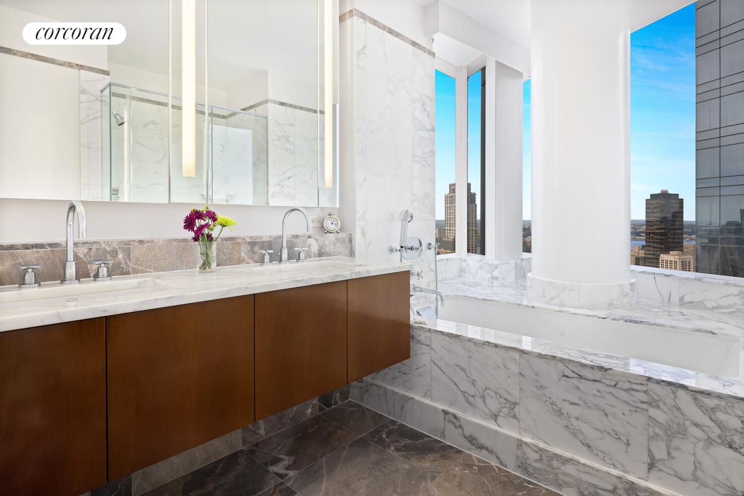 25 Columbus Circle, Unit 61G Manhattan, NY 10035 - Photo 9 of 23 a bathroom with a sink double vanity and a mirror