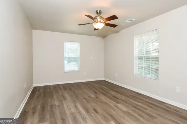 wooden floor in an empty room with a window