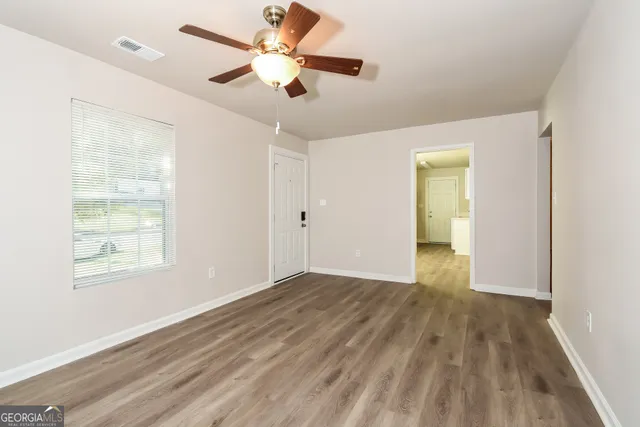 wooden floor in an empty room with a window