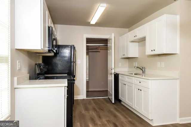 a kitchen with a sink a stove and refrigerator