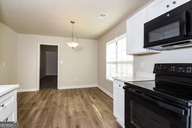 a kitchen with a stove and a microwave