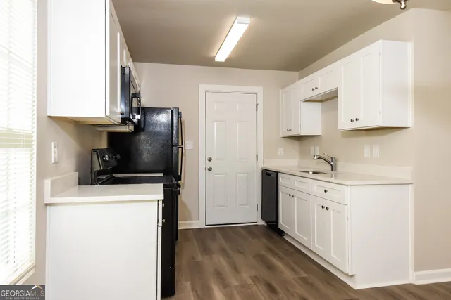a kitchen with stainless steel appliances a stove refrigerator sink and cabinets