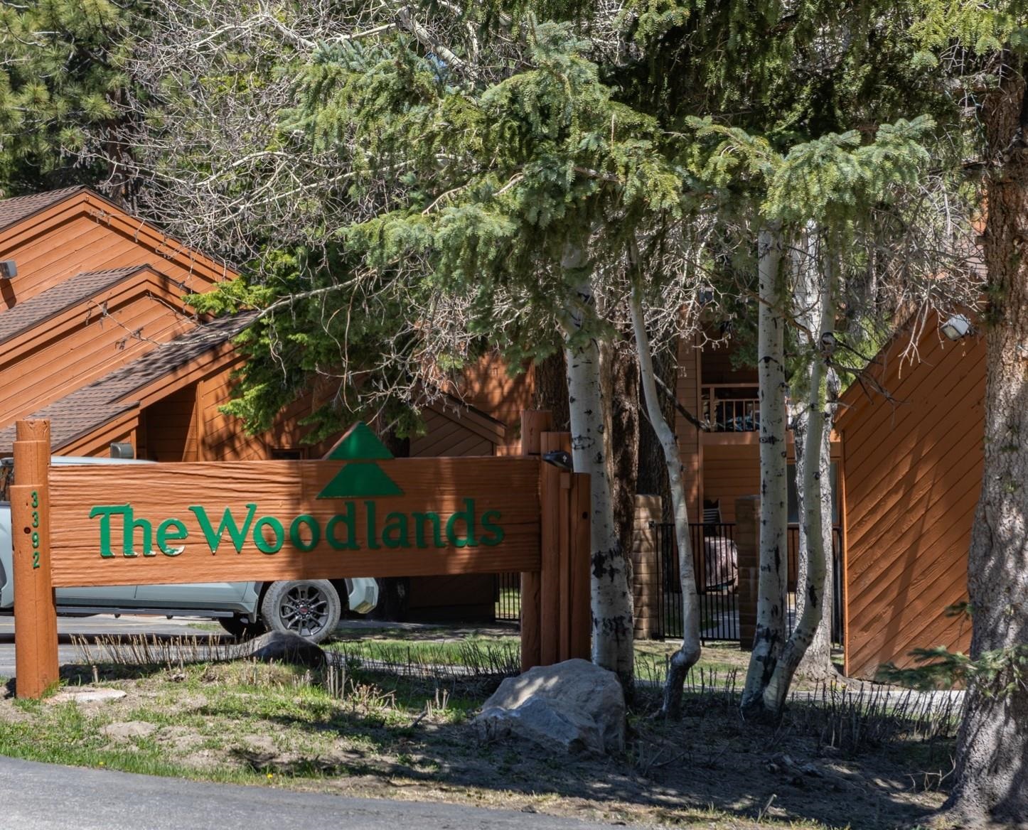 3392 Chateau Road, Unit 29 Mammoth Lakes, CA 93546 - Photo 27 of 30 Rustic wood-finish sign with green lettering and tree emblem