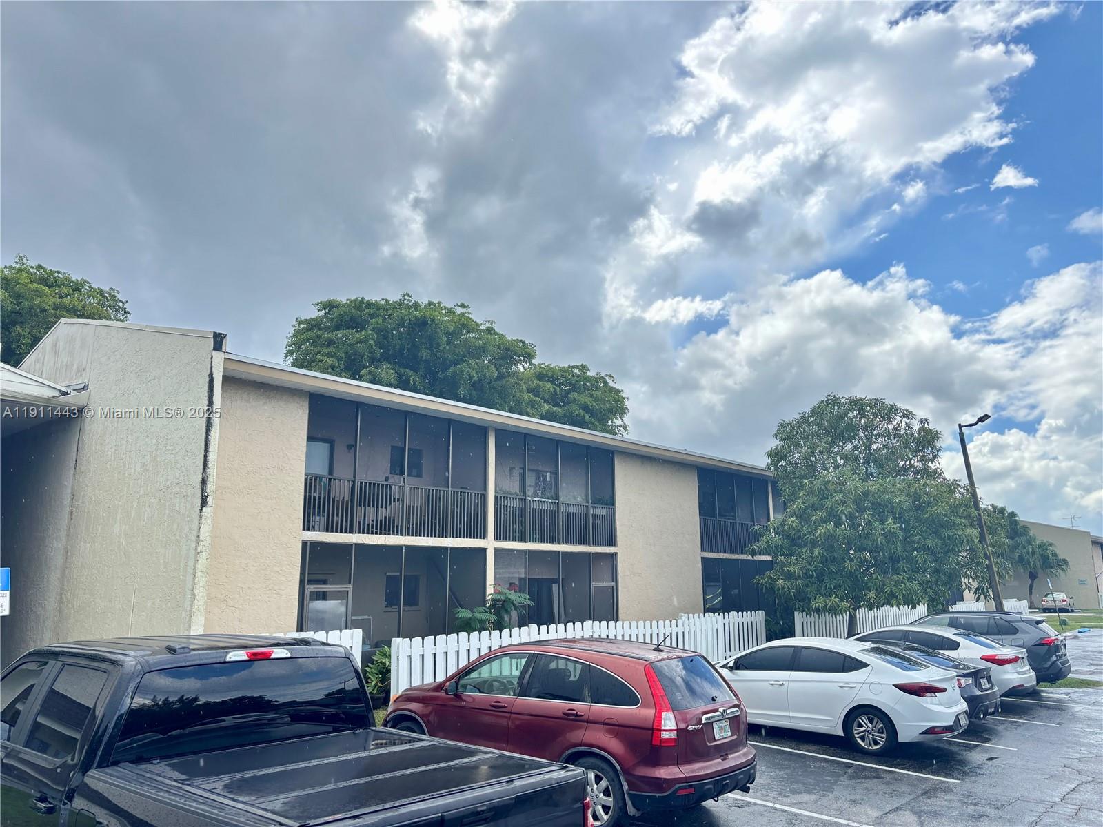 10350 Southwest 220th Street, Unit 251 Cutler Bay, FL 33190 - Photo 1 of 10 a view of a car parked in front of a house