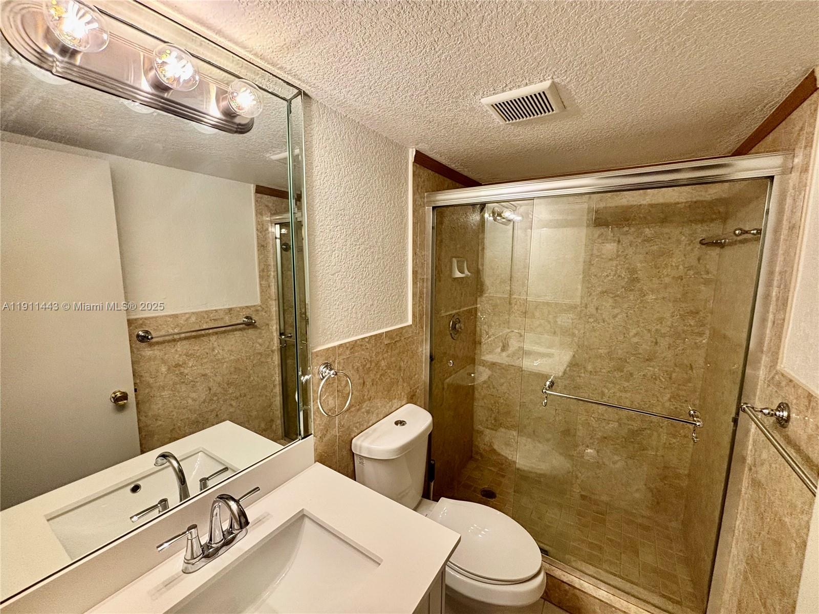 10350 Southwest 220th Street, Unit 251 Cutler Bay, FL 33190 - Photo 10 of 10 a bathroom with a sink mirror vanity and toilet