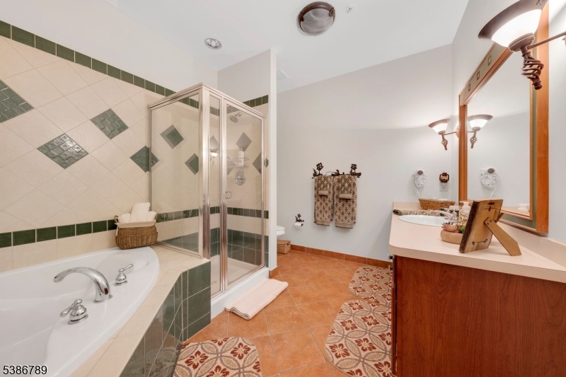 1 Maple Crescent, Unit 13 Vernon, NJ 07462 - Photo 12 of 29 a bathroom with a tub sink and mirror