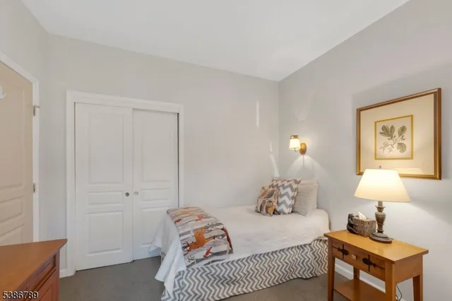 a bedroom with a bed and flat screen tv