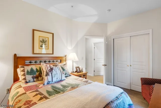 a bedroom with a bed and painting on the wall