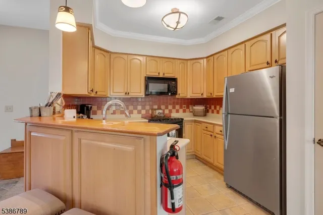 a kitchen with a refrigerator sink and stove