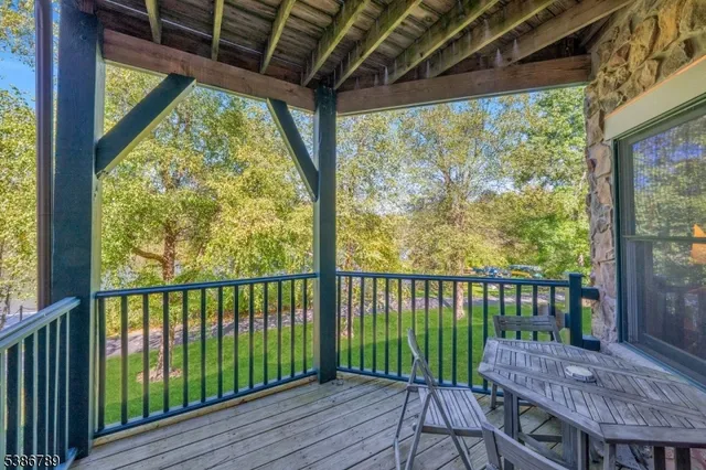 a view of a tables and chairs under an umbrella in a patio