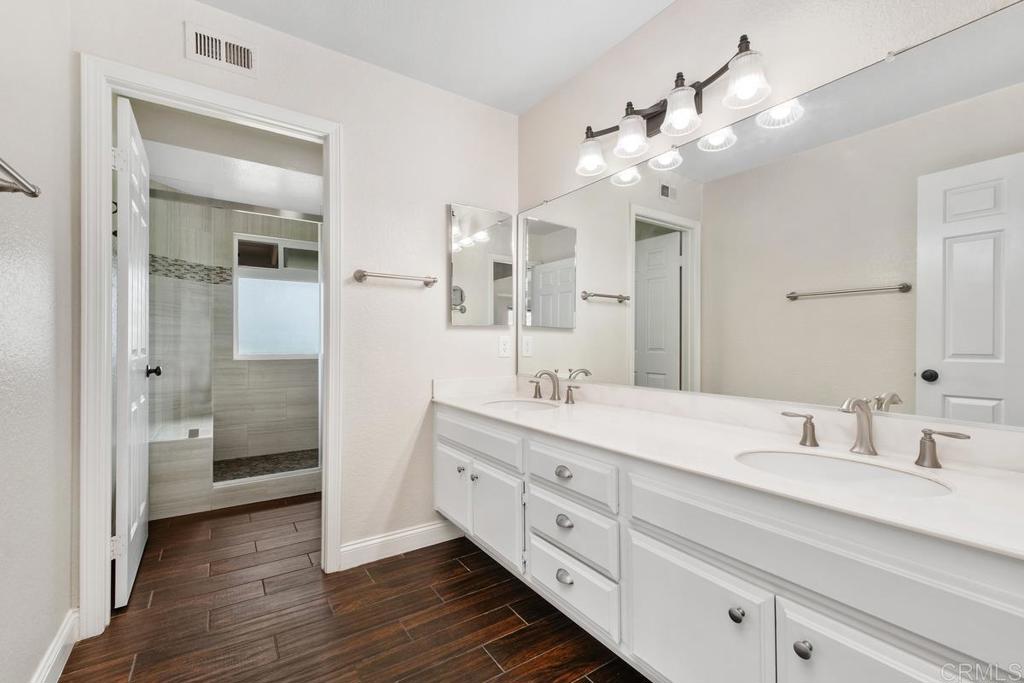 6 Cape Cod Irvine, CA 92620 - Photo 19 of 41 a bathroom with a double vanity sink mirror and shower