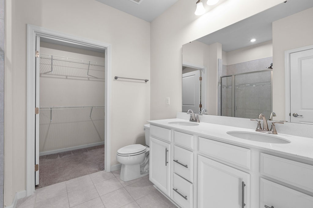 242 Marion Drive Spring Hill, TN 37174 - Photo 14 of 24 a bathroom with a toilet a sink a mirror and a shower