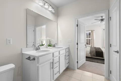 a bathroom with a sink a toilet and mirror