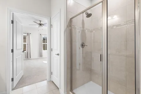 a bathroom with a glass shower door