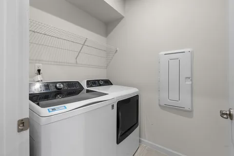 a view of storage and utility room with washer and dryer