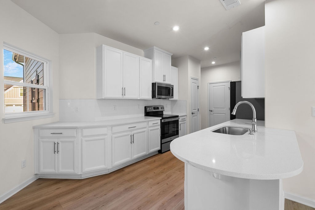 242 Marion Drive Spring Hill, TN 37174 - Photo 9 of 24 a kitchen with sink a microwave and cabinets