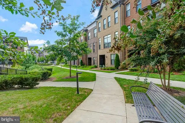 a front view of a residential apartment building with a yard