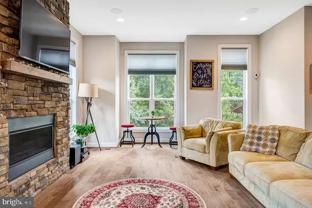 a dining room with stainless steel appliances kitchen island granite countertop a dining table chairs and a refrigerator