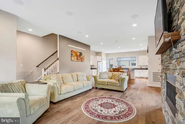 a kitchen with kitchen island granite countertop a sink stainless steel appliances and cabinets