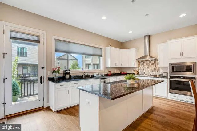 a bed sitting in a room next to a window with a chair