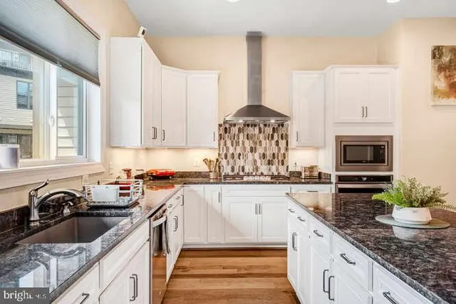 a front view of a house with trees