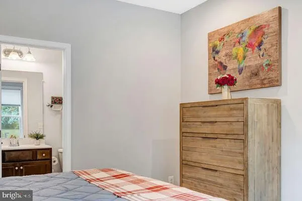 a living room with furniture a rug and a floor to ceiling window