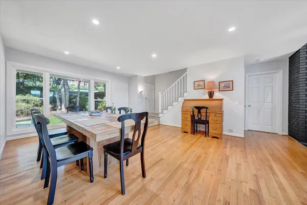 a living room with furniture a dining table and a flat screen tv