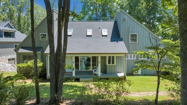 a front view of house with yard and green space