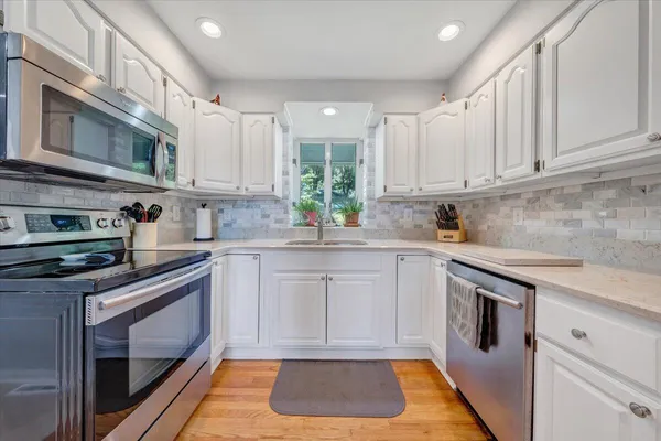 a spacious bedroom with a bed a couch and a window