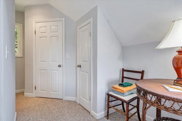 a backyard of a house with plants and large trees