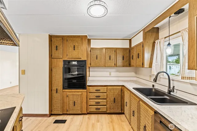 a kitchen with stainless steel appliances a stove sink and cabinets