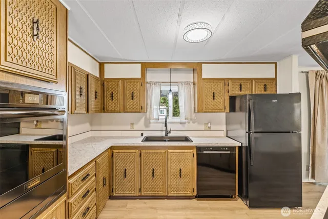 a kitchen with a sink appliances and cabinets