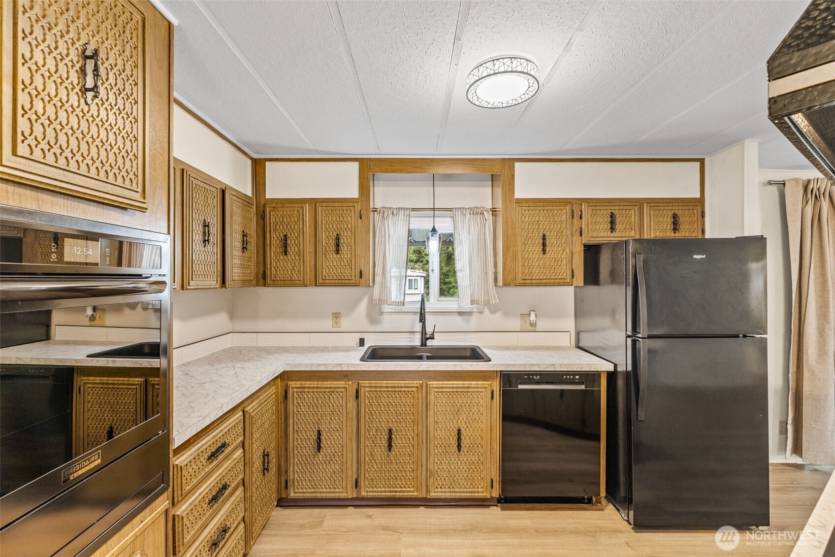 11330 East Riverside Drive, Unit 7 Bothell, WA 98011 - Photo 13 of 32 a kitchen with a sink appliances and cabinets