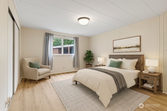 11330 East Riverside Drive, Unit 7 Bothell, WA 98011 - Photo 21 of 32 a bedroom with a large bed and a couch