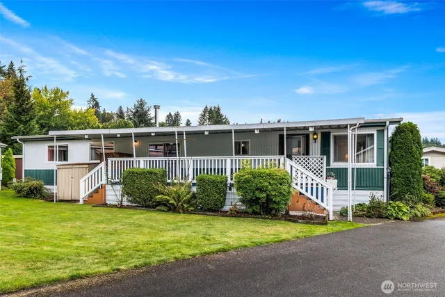 a view of a small room with wooden walls and door