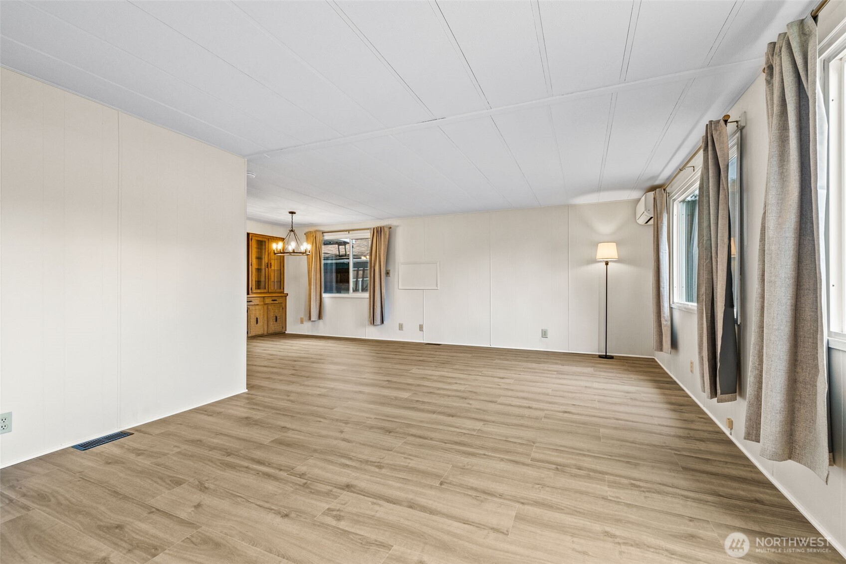 11330 East Riverside Drive, Unit 7 Bothell, WA 98011 - Photo 8 of 32 a view of a big room with wooden floor and windows