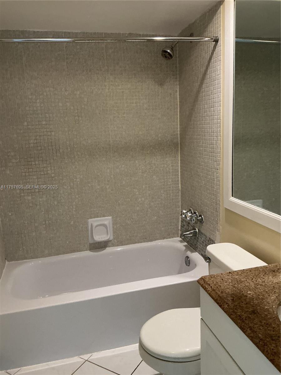 200 South Birch Road, Unit 404 Fort Lauderdale, FL 33316 - Photo 6 of 18 a bathroom with a granite countertop bathtub shower and toilet