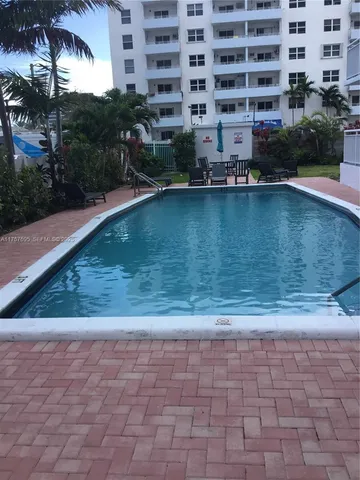 a view of swimming pool with outdoor seating and plants