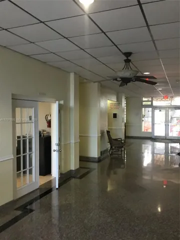 a lobby with furniture and a table