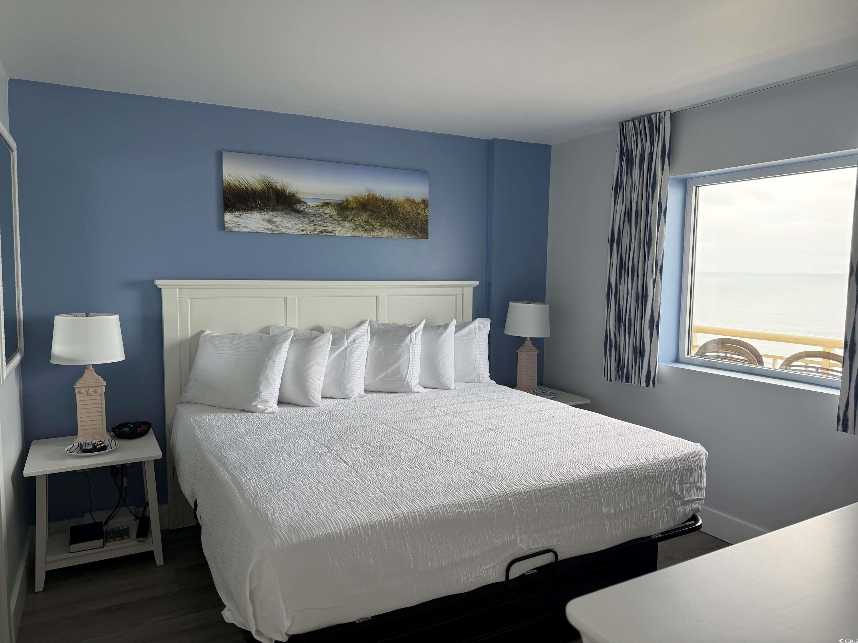 2000 North Ocean Boulevard, Unit CAMELOT 911 Myrtle Beach, SC 29577 - Photo 2 of 8 Bedroom with baseboards and wood finished floors