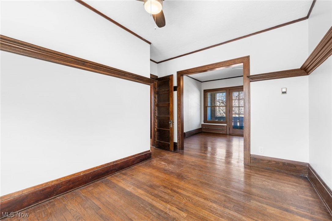 1905 Fulton Road, Unit 2B Cleveland, OH 44113 - Photo 10 of 31 Spare room featuring dark hardwood / wood-style flooring, ornamental molding, and ceiling fan